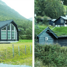 Svarte hytter med gresstak 